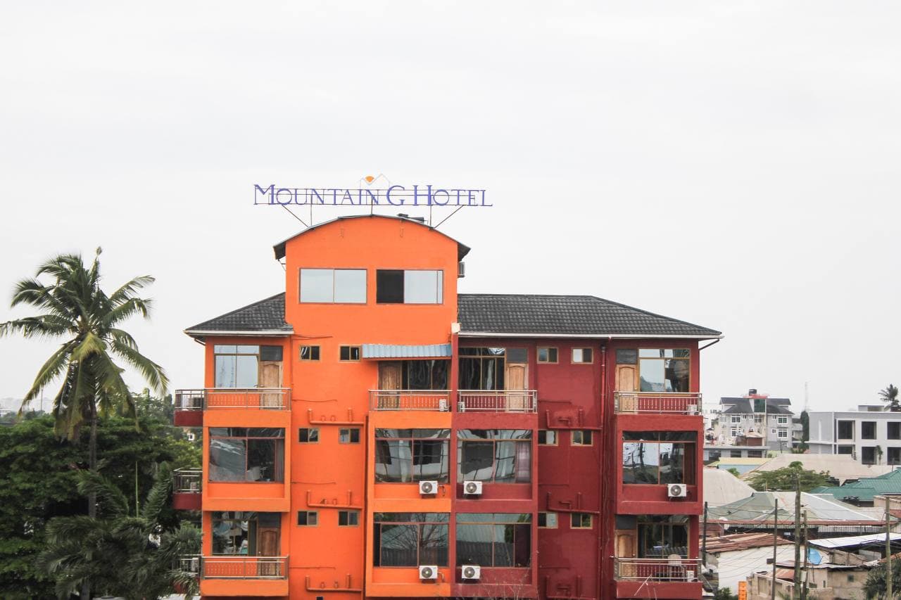 Mountain G Hotel, a four-storey orange and red building in Dar es Salaam